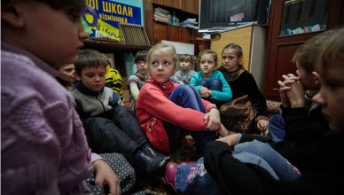 On 13 February 2017, first grade students, including Sasha (in red sweater), 6, participate in a drill to practice their response during a shelling in a part of the school building with strong walls. The school does not have a basement which can be used as a bomb shelter.  Sashas house is located some 15 kilometers from the contact line in Toretsk, Donetsk Region, Ukraine.  Sasha and her sister, Diana, have been living with their grandmother in this house since the beginning of the conflict in 2014 while their parents live in Donetsk city where they work.

As the volatile conflict in eastern Ukraine enters its fourth year, 1 million children are in urgent need of humanitarian assistance  nearly double the number this time last year, said UNICEF. The increase  an additional 420,000 girls and boys  is due to the continued fighting and the steady deterioration of life in eastern Ukraine, where some 1.7 million people have been internally displaced, and many families have lost their incomes, social benefits and access to healthcare, while the price of living has sharply risen. 

Hundreds of daily ceasefire violations put childrens physical safety and psychological well-being at risk. The situation is particularly grave for the approximately 200,000 girls and boys living within 15 kilometres on each side of the contact line in eastern Ukraine, a line which divides government and non-government controlled areas where fighting is most severe. In this zone, 19,000 children face constant danger from landmines and other unexploded ordinance and 12,000 children live in communities shelled at least once a month. Thousands of children are regularly forced to take refuge in improvised bomb shelters.