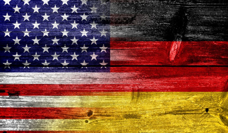 23424227 - usa and germany flag painted on old wood plank texture