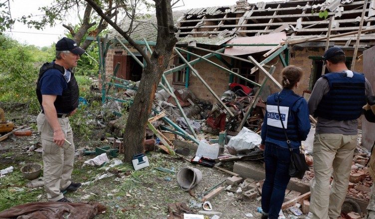 epa05963228 Observers of the Organization for Security and Co-operation in Europe (OSCE) inspect a private building, which was destroyed after a shelling of Avdiivka, Ukraine, 14 May 2017. Four civilian people were killed on the spot and another one was seriously injured after shelling of Avdiivka city on 13 May in the evening.  EPA/VALERI KVIT