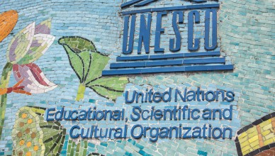 25092727 - hanoi, vietnam - circa march 2012: unesco logo on longest mosaic wall in the world. blue logo and name on colorful fresco.