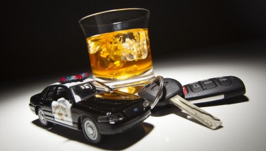 Highway Patrol Police Car Next to Alcoholic Drink and Key