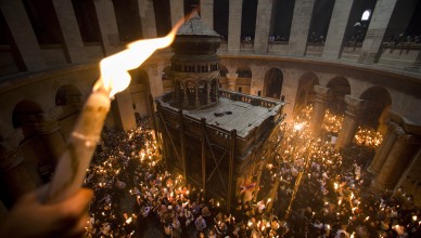 FILE - In this April 3, 2010 file photo Orthodox Christian pilgrims hold candles at the Church of the Holy Sepulcher, traditionally believed to be the site of the crucifixion of Jesus Christ, during the Holy Fire ceremony, in Jerusalem's Old City. Thousands of Christian believers will fill the medieval chambers of the Church of the Holy Sepulcher in Jerusalem on Saturday April 23, 2011 for a yearly ritual known as the Holy Fire, packed shoulder to shoulder and holding burning candles as pilgrims have done for centuries. And in 2011, as in centuries past, the church will have only one door and no fire exit.(AP Photo/Bernat Armangue, File)