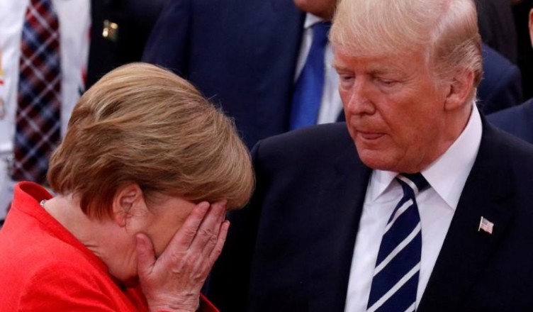 FILE PHOTO: German Chancellor Angela Merkel reacts next to U.S. President Donald Trump during the G20 leaders summit in Hamburg, Germany July 7, 2017. REUTERS/Philippe Wojazer/File Photo