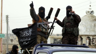 Members of al Qaeda's Nusra Front gesture as they drive in a convoy touring villages, which they said they have seized control of from Syrian rebel factions, in the southern countryside of Idlib, December 2, 2014. REUTERS/Khalil Ashawi