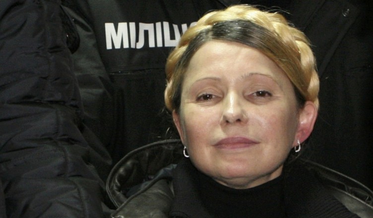 Ukrainian opposition leader Yulia Tymoshenko reacts after she was freed in Kharkiv February 22, 2014. Tymoshenko was freed on Saturday from the hospital where she had been held under prison guard for most of the time since she was convicted in 2011. The former prime minister, a bitter rival of President Viktor Yanukovich, waved to supporters from a car as she was driven out of the hospital in the northeastern city if Kharkiv, a Reuters photographer said. Tymoshenko, 53, was jailed in 2011 for abuse of office over a gas deal with Russia but her supporters and Western leaders say her trial was politically motivated.                REUTERS/Inna Petrykova  (UKRAINE  - Tags: POLITICS CIVIL UNREST TPX IMAGES OF THE DAY)