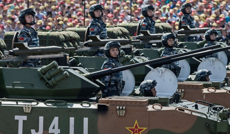 BEIJING, CHINA - SEPTEMBER 03:  Chinese soldiers ride in armoured vehicles as they pass in front of Tiananmen Square and the Forbidden City during a military parade on September 3, 2015 in Beijing, China. China is marking the 70th anniversary of the end of World War II and its role in defeating Japan with a new national holiday and a military parade in Beijing.  (Photo by Kevin Frayer/Getty Images)
