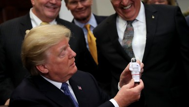 WASHINGTON, DC - DECEMBER 11:  AFP OUT  U.S. President Donald Trump holds a plastic astronaut figurine given to him by Apollo 17 astronaut and former U.S. Senator Jack Schmitt during a signing ceremony for 'Space Policy Directive 1' in the Roosevelt Room at the White House December 11, 2017 in Washington, DC. On the 45th anniversary of Apollo 17 -- the last crewed mission to the moon -- Trump signed the order directing NASA 'to lead an innovative space exploration program to send American astronauts back to the Moon, and eventually Mars,' according White House spokesman Hogan Gidley.  (Photo by Chip Somodevilla/Getty Images)