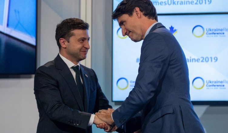 Canadian Prime Minister Justin Trudeau (R) and Ukrainian President Volodymyr Zelensky embrace after Trudeau's address to the Ukrainian Reform conference in Toronto, Ontario, on July 2, 2019. (Photo by Lars Hagberg / AFP)