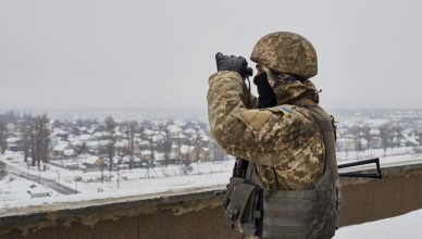 AVDIIVKA, UKRAINE - JANUARY 8: A Ukrainian serviceman eyes the frontline atop a building in the frontline city of Avdiivka as Ukrainian forces pushed back an attack by pro-Russian rebels on January 8, 2016 in Avdiivka, Ukraine. German Chancellor Angela Merkel has said she believes there could be progress in negotiations on the Ukraine crisis over the next few months as the Normandy negotiations take place between France, Germany, Russia and Ukraine. (Photo by Pierre Crom/Getty Images)