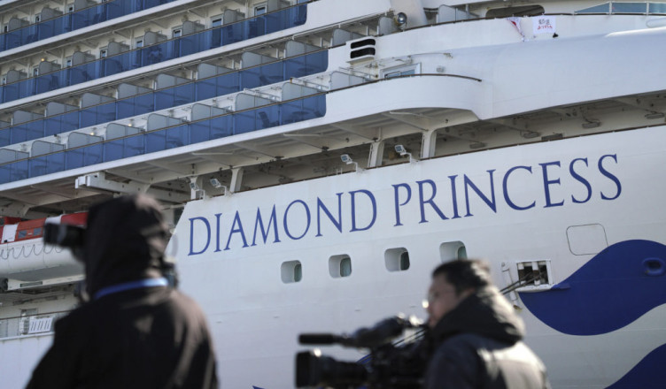 The quarantined cruise ship Diamond Princess is anchored in the Yokohama Port Sunday, Feb. 9, 2020. Japan on Saturday reported three more cases of the coronavirus aboard the Diamond Princess for a total of 64 . There are 3,700 passengers and crew on the Diamond Princess who must remain on board for 14 days. (AP Photo/Eugene Hoshiko)