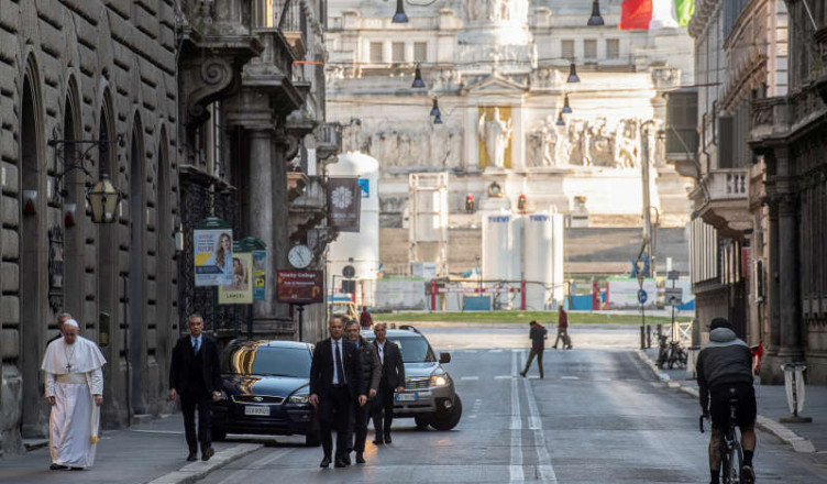 Pope Francis walks in a deserted Rome to pray at two shrines for the end of the coronavirus pandemic, in Rome, Italy March 15, 2020. Vatican Media/?Handout via REUTERS ATTENTION EDITORS - THIS IMAGE WAS PROVIDED BY A THIRD PARTY.     TPX IMAGES OF THE DAY