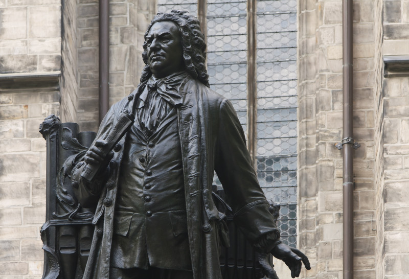 "Johann Sebastian Bach Statue in front of St Thomas's Church, Leipzig (Germany). In front of the south portal of St. Thomas's Church in the City of Leipzig stands the 2.45m high statue of Johann Sebastian Bach. Bach was one of the most famous composer, organist, harpsichordist and violist in Germany. Bach lived from 21 March 1685 until 28 July 1750. In 1723, Bach was appointed Cantor of the Thomasschule at St. Thomas Church in Leipzig, as well as Director of Music in the principal churches in the town. The artist of the sculpture was Carl Seffner (1861- 1932). He created this in 1908."