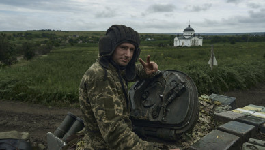 A Ukrainian soldier shows a victory sign atop a tank at the frontline near Bakhmut, Donetsk region, Ukraine, Saturday, June 17, 2023. (AP Photo/Libkos)