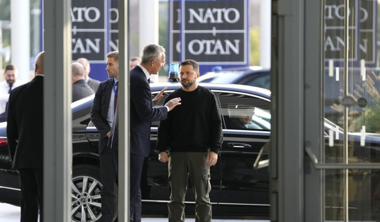 NATO Secretary General Jens Stoltenberg, center left, speaks with Ukraine's President Volodymyr Zelenskyy, right, on arrival prior to a meeting of NATO defense ministers at NATO headquarters in Brussels, Wednesday, Oct. 11, 2023. (AP Photo/Virginia Mayo)
