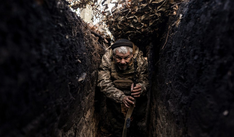 LUGANSK OBLAST, UKRAINE - NOVEMBER 14: A Ukrainian soldier walks through a trench at his infantry position in the direction of Lugansk Oblast as Russia and Ukraine war continues in Ukraine on November 14, 2023. (Photo by Diego Herrera Carcedo/Anadolu via Getty Images)