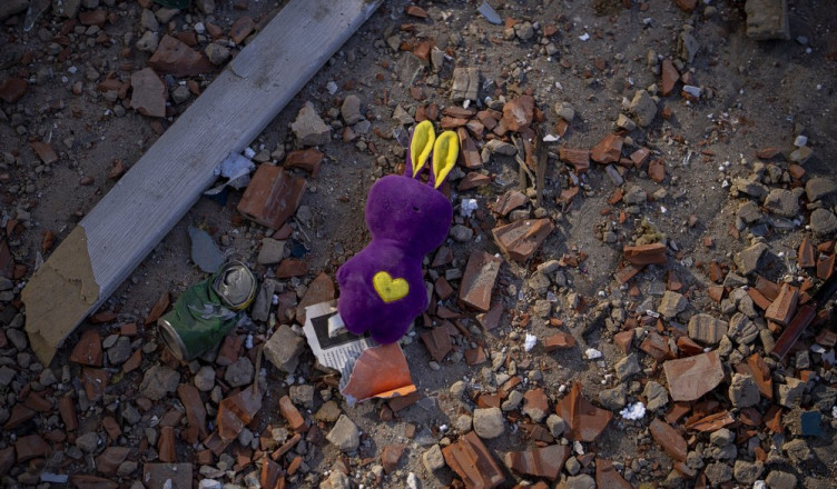 A toy sits among the debris near an apartment building damaged following a rocket attack, in Kyiv, Ukraine, Saturday, Feb. 26, 2022. (AP Photo/Emilio Morenatti)