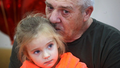 KYIV, UKRAINE - NOVEMBER 28, 2023 - Grandfather Valerii holds his granddaughter Miia, 3, who recovers from surgery that saw a fragment of a Russian mine extracted from her heart. The girl was diagnosed with blast and traumatic brain injuries, multiple shrapnel wounds, penetrating chest wound, general and lung contusion. Miia had been transported to Kyiv where doctors removed a piece of a Russian mine from her heart on November 23. (Photo credit should read Yuliia Ovsiannikova / Ukrinform/Future Publishing via Getty Images)