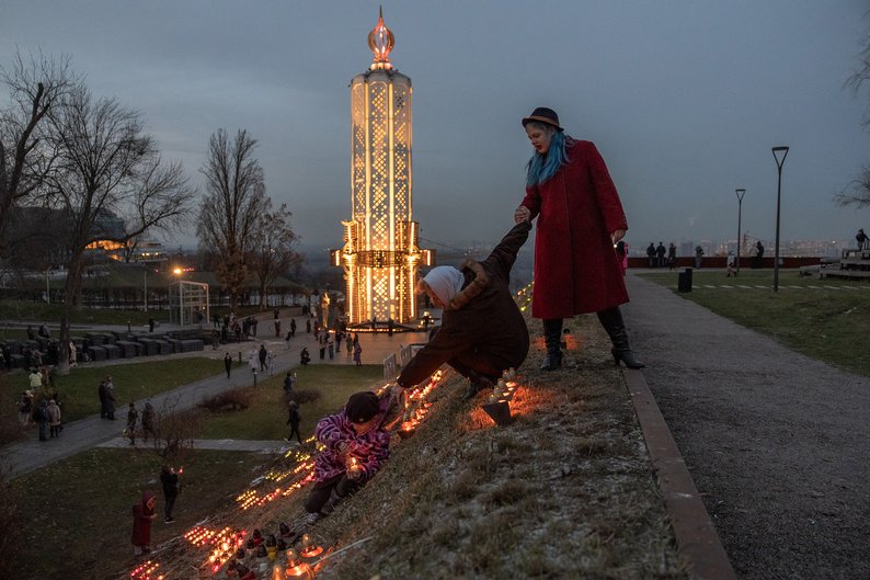 TOPSHOT - People light candles in tribute to the victims of the famine of 1932-1933 at the National Museum of the Holodomor-Genocide in Kyiv, on November 25, 2023, amid the Russian invasion of Ukraine. Ukraine marked 90 years since the Stalin-era Holodomor famine, one of the darkest momments in it's history that left millions dead. Ukrainian President Volodomyr Zelensky said on November 25, 2023 it was "impossible" to forgive the "crimes of genocide" during a famine that took place under the rule of Soviet dictactor Joseph Stalin. (Photo by Roman PILIPEY / AFP) (Photo by ROMAN PILIPEY/AFP via Getty Images)