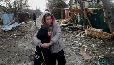 TOPSHOT - Local residents stand among debris on the street outside a house destroyed as a result of a drone attack in Tairove (alternatively spelled "Tayirove"), Odesa region, on December 17, 2023. (Photo by Anatolii STEPANOV / AFP) (Photo by ANATOLII STEPANOV/AFP via Getty Images)