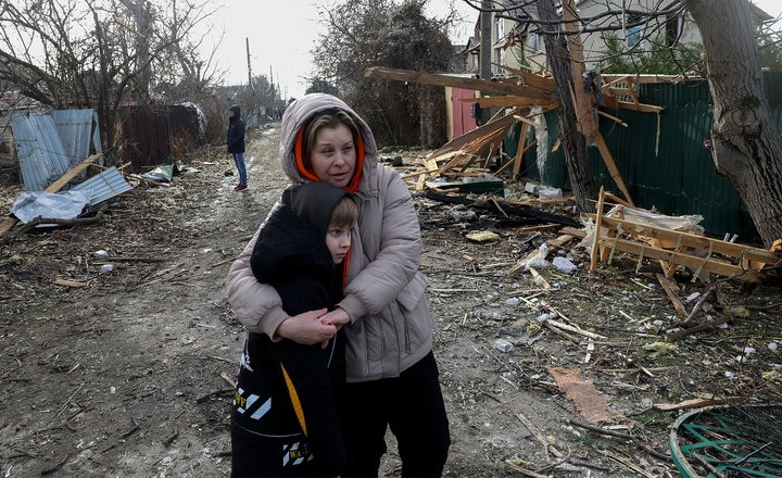 TOPSHOT - Local residents stand among debris on the street outside a house destroyed as a result of a drone attack in Tairove (alternatively spelled "Tayirove"), Odesa region, on December 17, 2023. (Photo by Anatolii STEPANOV / AFP) (Photo by ANATOLII STEPANOV/AFP via Getty Images)