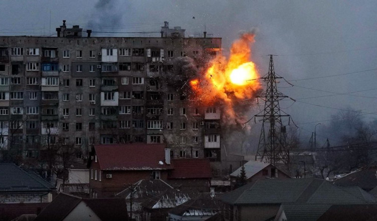 An apartment building explodes after a Russian army tank fires in Mariupol, Ukraine, Friday, March 11, 2022. (AP Photo/Evgeniy Maloletka)
