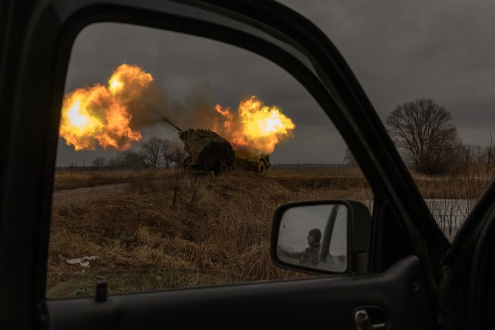 TOPSHOT - A Ukrainian soldier reflected in a car mirror looks at Swedish-made Archer Howitzer operated by Ukrainian members of the 45th Artillery Brigade firing toward Russian positions, in the Donetsk region, on January 20, 2024, amid the Russian invasion of Ukraine. (Photo by Roman PILIPEY / AFP) (Photo by ROMAN PILIPEY/AFP via Getty Images)