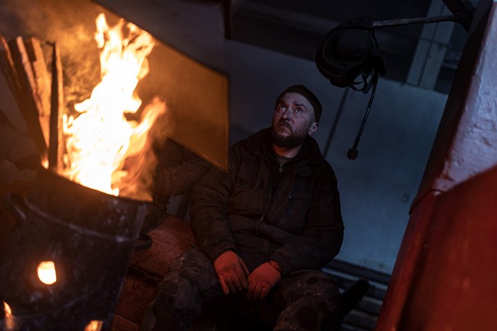 DONETSK OBLAST, UKRAINE - 11 FEBRUARY: Ukrainian soldier warms himself next to a bonfire in the direction of Bakhmut, where clashes between Russia and Ukraine continue to take place, Donetsk Oblast, Ukraine, 11 February 2024. (Photo by Diego Herrera Carcedo/Anadolu via Getty Images)