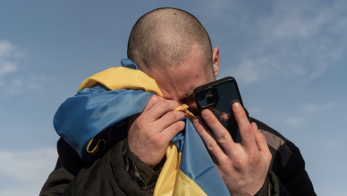 A recently swapped Ukrainian prisoner of war cries while calling his relatives after a prisoner exchange on the Ukrainian Russian border, on Wednesday, Jan. 31, 2024. Russia and Ukraine have exchanged about 200 prisoners of war each, the countries said Wednesday, despite tensions stemming from last week's crash of a military transport plane that Moscow claimed was carrying Ukrainian POWs and was shot down by Kyiv's forces. (AP Photo/Danylo Pavlov)