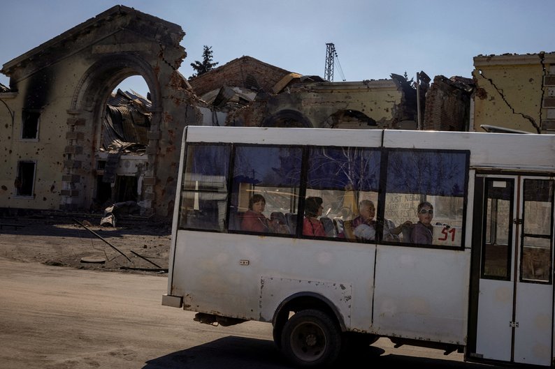 People look at the damage from shelling as they ride a local bus past the train station in Kostiantynivka, amid Russia's attack on Ukraine, April 10, 2024. REUTERS/Thomas Peter     TPX IMAGES OF THE DAY