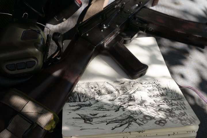 TOPSHOT - A photograph taken on a position at a field near Chasiv Yar, Donetsk region, on May 1, 2024, shows drawings in the sketchbook of Ukrainian reconnaissance drone pilot of the 22nd Brigade Andriy, 48, called "Roy" from his war name, amid the Russian invasion of Ukraine. When Russia invaded Ukraine, Andriy volunteered to fight, becoming a machine-gunner and then a drone pilot. And "to keep from going mad", this architect began to draw the horrors of war. (Photo by Genya SAVILOV / AFP) / RESTRICTED TO EDITORIAL USE - MANDATORY MENTION OF THE ARTIST UPON PUBLICATION - TO ILLUSTRATE THE EVENT AS SPECIFIED IN THE CAPTION (Photo by GENYA SAVILOV/AFP via Getty Images)