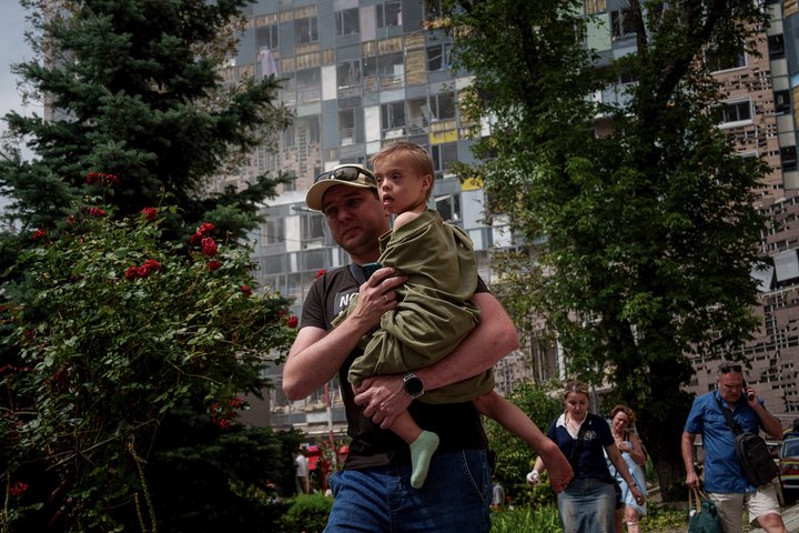 A child is carried near the site of Okhmatdyt children’s hospital hit by Russian missiles, in Kyiv, Ukraine, Monday, July 8, 2024. Russian missiles have killed several people and struck a children’s hospital in the Ukrainian capital, Kyiv, authorities say. (AP Photo/Evgeniy Maloletka)
