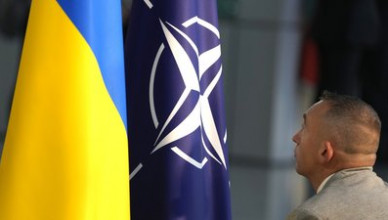 A member of protocol sets up the NATO and Ukrainian flags prior to a media conference of Ukraine's President Volodymyr Zelenskyy and NATO Secretary General Jens Stoltenberg during a meeting of NATO defense ministers at NATO headquarters in Brussels, Wednesday, Oct. 11, 2023. Ukraine's President Volodymyr Zelenskyy has arrived at NATO for meetings with alliance defense ministers to further drum up support for Ukraine's fight against Russia. (AP Photo/Virginia Mayo)