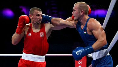 Hungary's Pylyp Akilov (in blue) fights against Ukraine's Oleksandr Khyzhniak in the men's 80kg preliminaries round of 16 boxing match during the Paris 2024 Olympic Games at the North Paris Arena, in Villepinte on July 30, 2024. (Photo by MOHD RASFAN / AFP) (Photo by MOHD RASFAN/AFP via Getty Images)