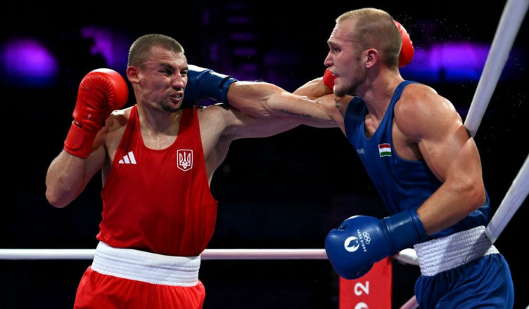 Hungary's Pylyp Akilov (in blue) fights against Ukraine's Oleksandr Khyzhniak in the men's 80kg preliminaries round of 16 boxing match during the Paris 2024 Olympic Games at the North Paris Arena, in Villepinte on July 30, 2024. (Photo by MOHD RASFAN / AFP) (Photo by MOHD RASFAN/AFP via Getty Images)