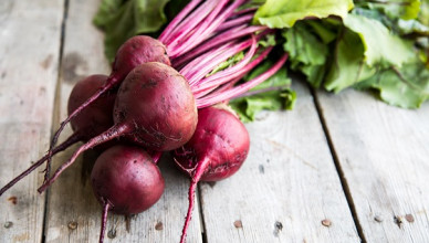 Red,Beetroot,With,Herbage,Green,Leaves,On,Rustic,Background.,Organic