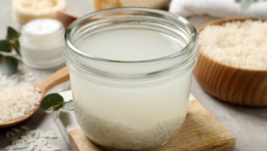 Glass,Jar,With,Rice,Soaked,In,Water,On,Light,Grey