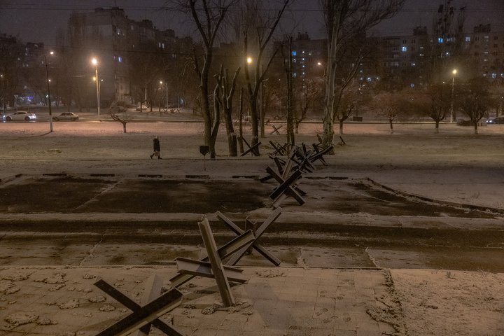 TOPSHOT - A pedestrian walks past metal tank barriers, also known as Czech hedgehog, in the Saltivka district that was heavily damaged during Russian attacks in 2022, in Kharkiv, on December 5, 2024, amid the Russian invasion of Ukraine. (Photo by Roman PILIPEY / AFP) (Photo by ROMAN PILIPEY/AFP via Getty Images)