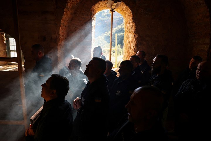 Recovering Ukrainian soldiers pray at the Holy Cell of Saints Archangels Falakrou in Mount Athos, Greece, November 25, 2024. In their four-day stay, part of a psychological support programme organised by Ukrainian authorities, the 22 soldiers made a pilgrimage to some dozen monasteries on the slopes of Mount Athos, a spiritual centre since the 10th century. "A lot of servicemen suffer from the events that took place over the last three years. A lot of them suffer from different illnesses – they are wounded, and we have to rehabilitate them," said Father Mykhailo Pasirskyi, a Ukrainian Orthodox priest. REUTERS/Alexandros Avramidis          SEARCH "AVRAMIDIS UKRAINE ATHOS" FOR THIS STORY. SEARCH "WIDER IMAGE" FOR ALL STORIES.          TPX IMAGES OF THE DAY