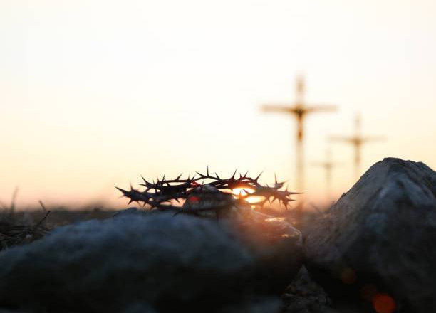 The cross and crown of thorns of Jesus Christ symbolizing suffering and great trials on Calvary's Golgotha Hill, the death of Jesus during Passion Week, and the background of Lent and Easter