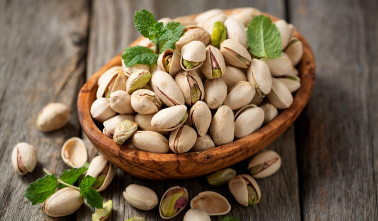 Bowl,With,Pistachios,On,A,Wooden,Table.