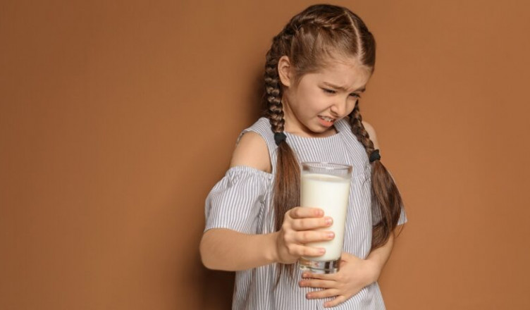 Little,Girl,With,Dairy,Allergy,Holding,Glass,Of,Milk,On