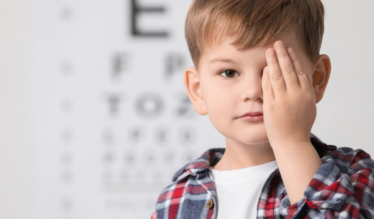 Little,Boy,Covering,Her,Eye,Against,Vision,Test,Chart